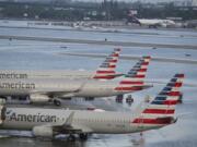 Airplanes sit on the runway due to flooding at Fort Lauderdale Hollywood airport Thursday, April 13, 2023 in Fort Lauderdale, Fla.  Nearly a foot of rain fell in a matter of hours in Fort Lauderdale - causing widespread flooding, the closure of the city's airport, all public schools and the suspension of high-speed commuter rail service.