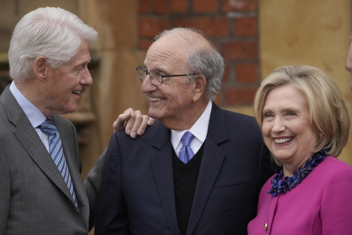 Former US President Bill Clinton, from left, former U.S. Sen. George Mitchell, and former US Secretary of State Hillary Clinton chat on the first day of a three-day international conference at Queen's University Belfast to mark the 25th anniversary of the Good Friday Agreement, in Belfast, Northern Ireland, Monday, April 17, 2023. Former U.S. President Bill Clinton and past leaders of the U.K. and Ireland are gathering in Belfast on Monday, 25 years after their charm, clout and determination helped Northern Ireland strike a historic peace accord.