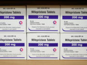 FILE - Boxes of the drug mifepristone sit on a shelf at the West Alabama Women's Center in Tuscaloosa, Ala., on March 16, 2022. Oregon Gov. Tina Kotek said Thursday, April 20, 2023 she has directed the state to obtain a supply of the most commonly used abortion medication in the U.S. amid fears that a court ruling could restrict access to it.  (AP Photo/Allen G.