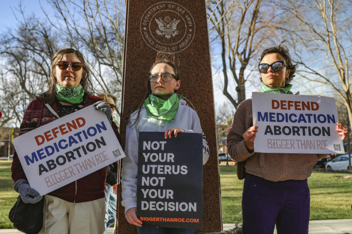 FILE - Three members of the Women's March group protest in support of access to abortion medication outside the Federal Courthouse on Wednesday, March 15, 2023 in Amarillo, Texas. Matthew Kacsmaryk, a Texas judge who sparked a legal firestorm with an unprecedented ruling halting approval of the nation's most common method of abortion, Friday, April 7, 2023, is a former attorney for a religious liberty legal group with a long history pushing conservative causes.