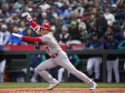 Los Angeles Angels' Shohei Ohtani follows through on an RBI single to score Taylor Ward during the seventh inning of a baseball game against the Seattle Mariners, Wednesday, April 5, 2023, in Seattle.