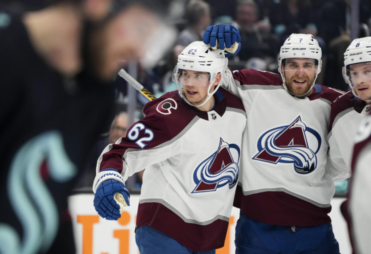 Colorado Avalanche left wing Artturi Lehkonen (62) celebrates his goal against the Seattle Kraken with teammates Devon Toews (7) and Cale Makar (8.