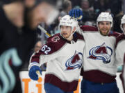 Colorado Avalanche left wing Artturi Lehkonen (62) celebrates his goal against the Seattle Kraken with teammates Devon Toews (7) and Cale Makar (8.