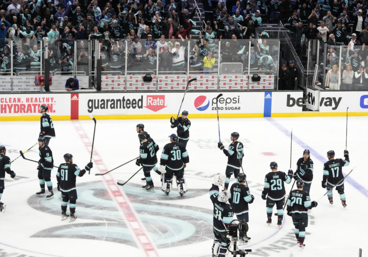 The Seattle Kraken celebrate a 3-2 victory over the Colorado Avalanche in overtime in Game 4 of a  first-round playoff series Monday in Seattle.