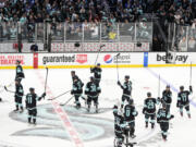 The Seattle Kraken celebrate a 3-2 victory over the Colorado Avalanche in overtime in Game 4 of a  first-round playoff series Monday in Seattle.