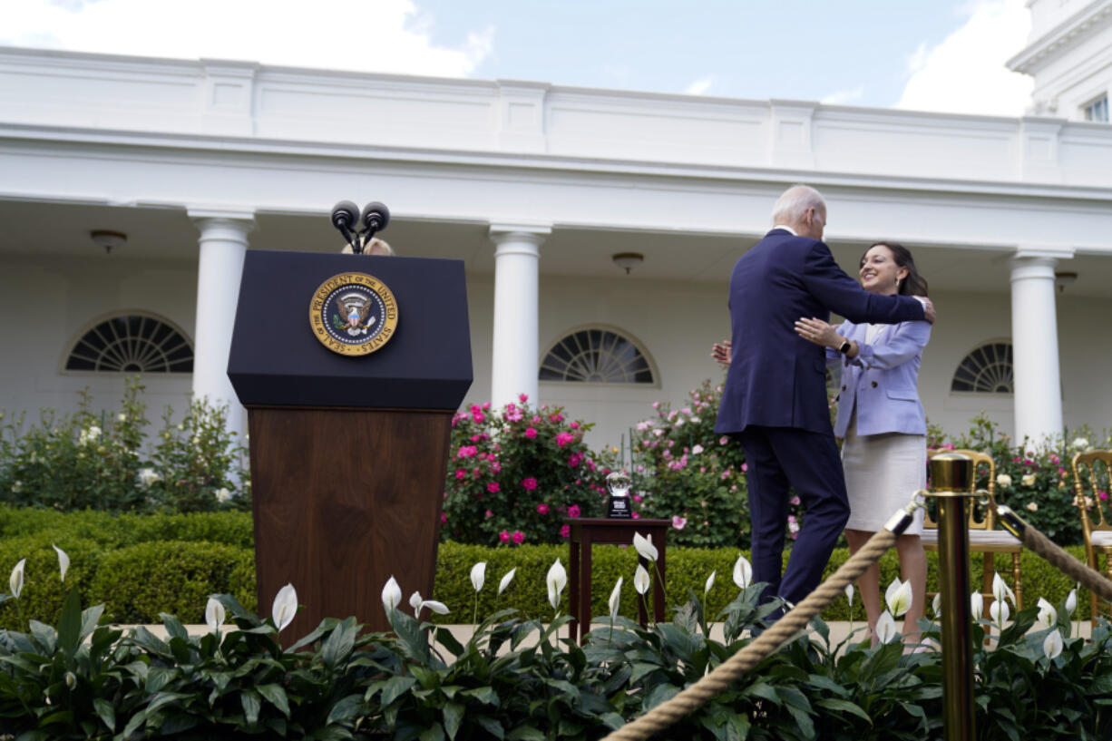 President Joe Biden hugs Rebecka Peterson, 2023 National Teacher of the Year, during a ceremony honoring the Council of Chief State School Officers' 2023 Teachers of the Year in the Rose Garden of the White House, Monday, April 24, 2023, in Washington.