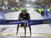 Susannah Scaroni breaks the tape to win the women's wheelchair division of the 127th Boston Marathon Monday, April 17, 2023, in Boston.