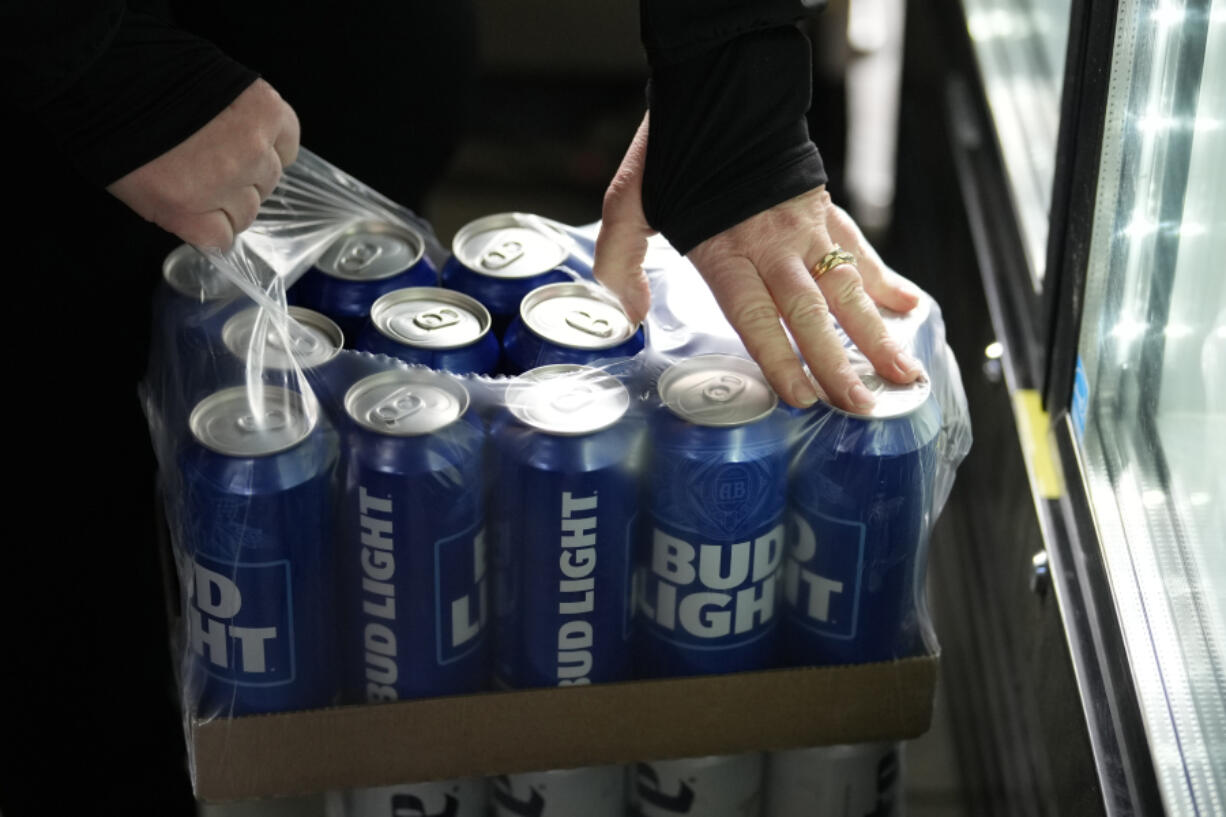 A stadium worker opens a case of Bud Light beer before a baseball game between the Philadelphia Phillies and the Seattle Mariners, Tuesday, April 25, 2023, in Philadelphia.