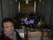 Ron Caetano stands in a trailer packed with his family's belongings in anticipation of flooding of the Kings River in the Island district of Lemoore, Calif., Wednesday, April 19, 2023. Caetano packed photos and valuables in a trailer and food in carry totes so he can leave home in less than an hour should the river water rush in. (AP Photo/Jae C.