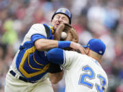 Seattle Mariners catcher Cal Raleigh, left, collides with first baseman Ty France (23) as he catches a foul ball for an out against St. Louis Cardinals' Dylan Carlson during the seventh inning of a baseball game Sunday, April 23, 2023, in Seattle.