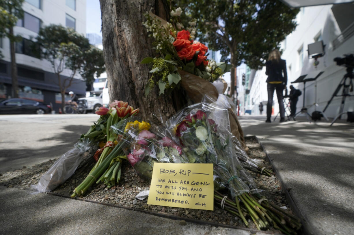 Flowers sit at a tree in front of the building where a technology executive was fatally stabbed outside of in San Francisco, Thursday, April 6, 2023. Details of how tech executive Bob Lee came to be fatally stabbed in downtown San Francisco early Tuesday were scarce as friends and family continued to mourn the man they called brilliant, kind and unlike others in the industry.
