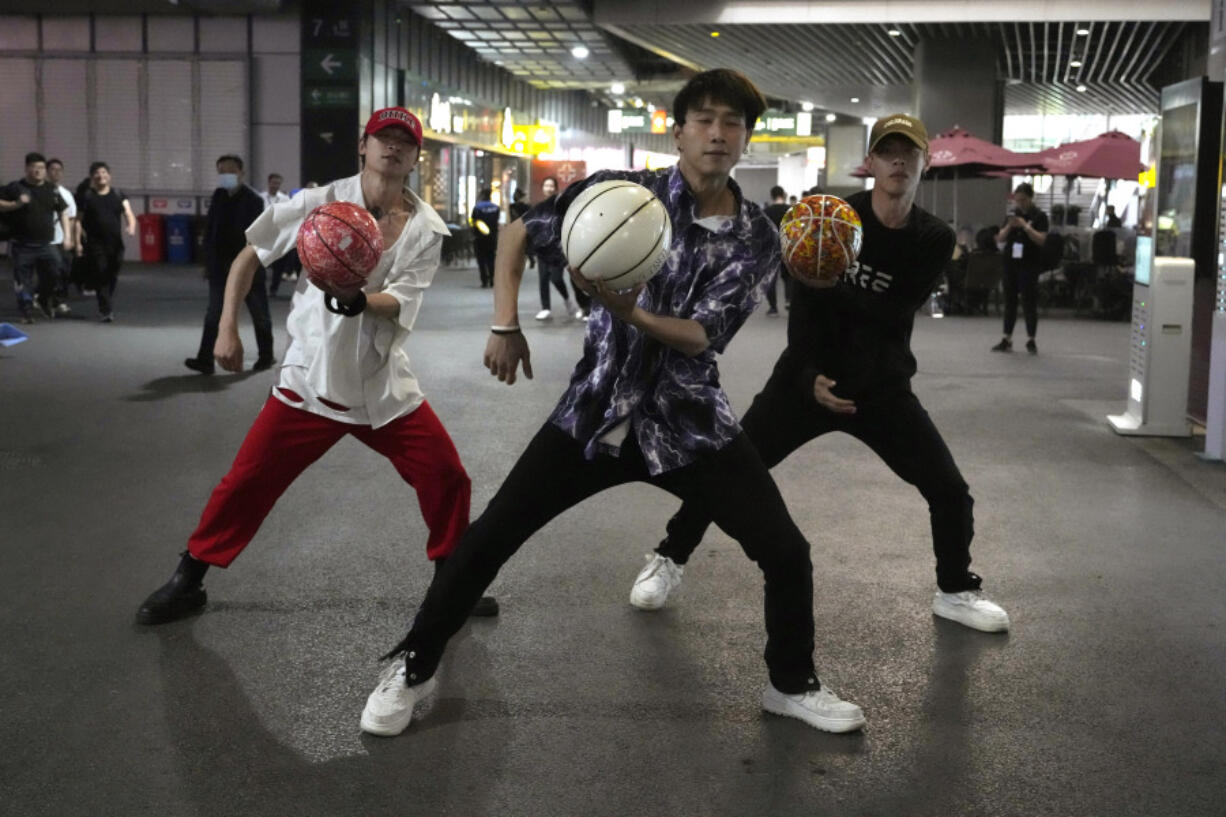 A basketball performance group dance for their Douying channel, the Chinese version of Tik Tok during Auto Shanghai 2023 show in Shanghai, Tuesday, April 18, 2023. Global and Chinese automakers plan to unveil more than a dozen new electric SUVs, sedans and muscle cars this week at the Shanghai auto show, their first full-scale sales event in four years in a market that has become a workshop for developing electrics, self-driving cars and other technology.