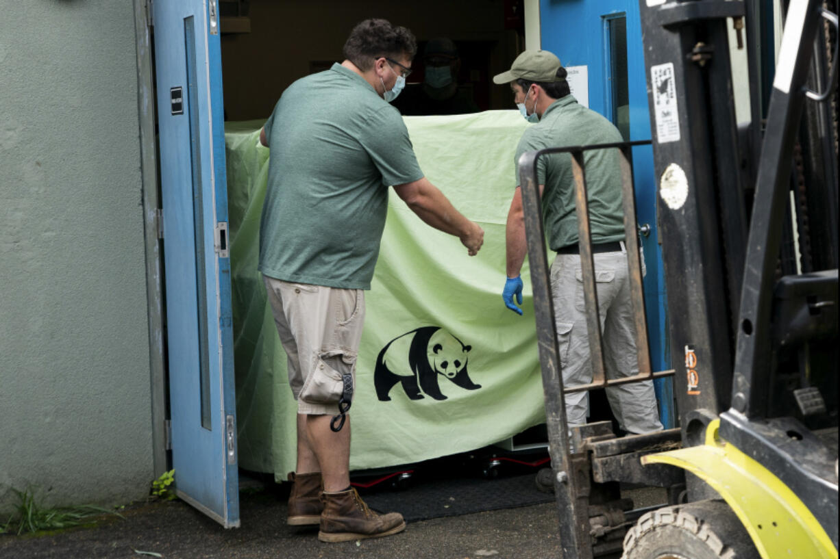 In this photo released by Xinhua News Agency, workers transfer a cage loaded with giant panda Ya Ya at the Memphis Zoo in Memphis, Tenn., on April 26, 2023. Ya Ya the giant panda landed in Shanghai Thursday, April 27 afternoon after departing from the Memphis Zoo, where it has spent the past 20 years on loan.