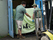 In this photo released by Xinhua News Agency, workers transfer a cage loaded with giant panda Ya Ya at the Memphis Zoo in Memphis, Tenn., on April 26, 2023. Ya Ya the giant panda landed in Shanghai Thursday, April 27 afternoon after departing from the Memphis Zoo, where it has spent the past 20 years on loan.