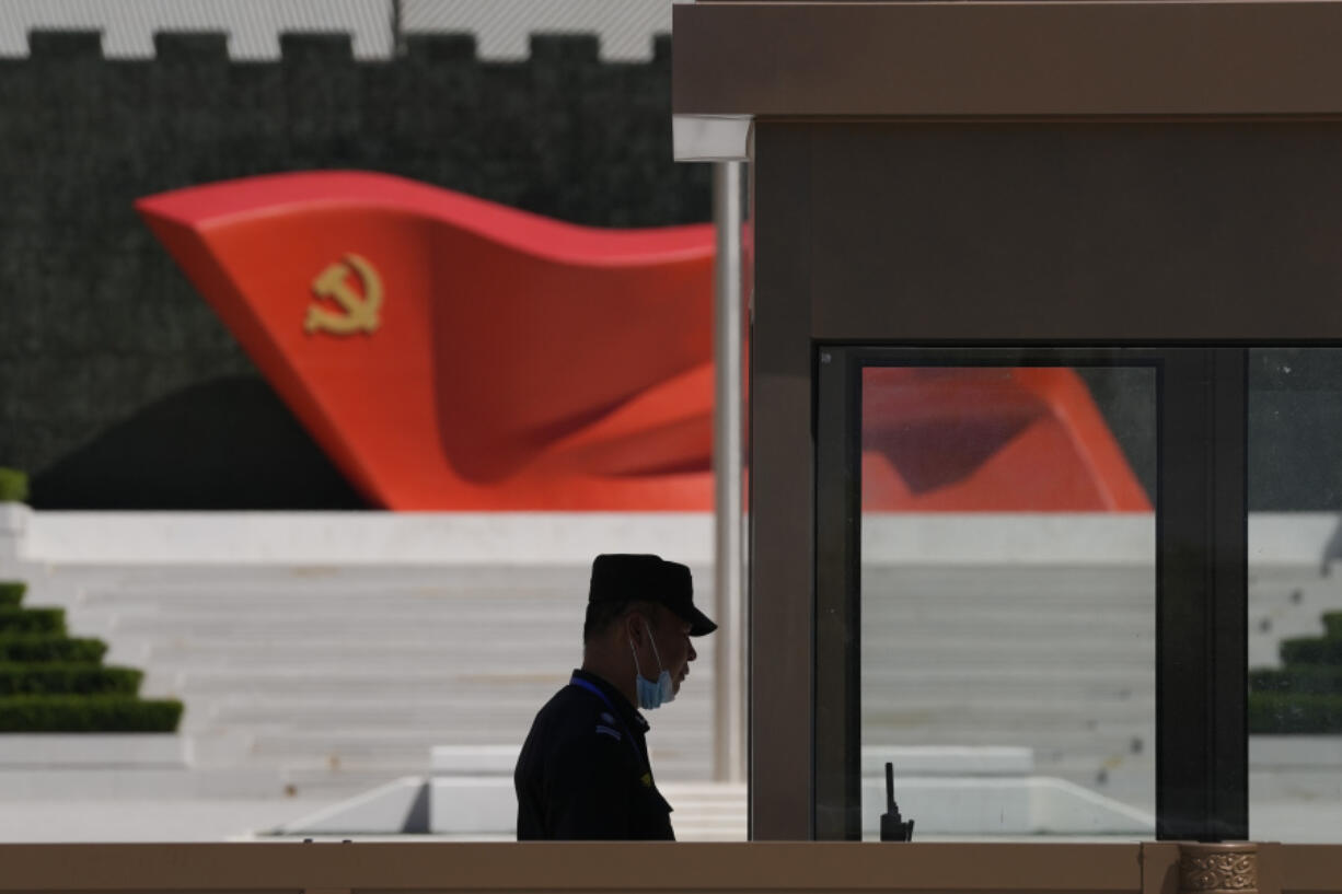 FILE - A security guard stands near a sculpture of the Chinese Communist Party flag at the Museum of the Communist Party of China on May 26, 2022, in Beijing. China's military flew 38 fighter jets and other warplanes near Taiwan, the Taiwanese defense ministry said Friday, April 28, 2023, in the largest such flight display since the large military exercise in which it simulated sealing off the island earlier in the month.