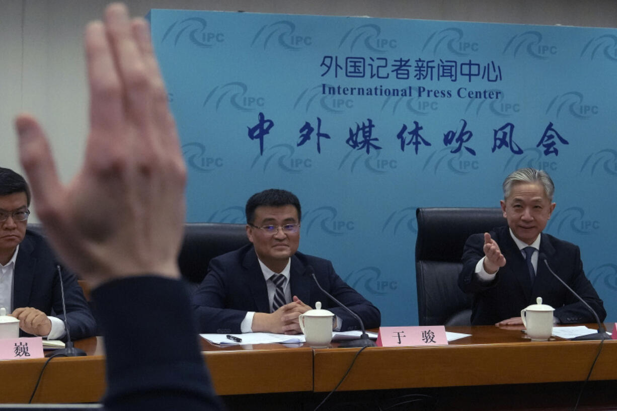 Deputy Director of Department of Eurasia of Ministry of Foreign Affairs Yu Jun, center, looks as Chinese Foreign Ministry spokesperson Wang Wenbin, right, gestures to a reporter to take a question during a news conference after Chinese President Xi Jinping had a phone conversation with Ukrainian President Volodymyr Zelenskyy, at the Ministry of Foreign Affairs office in Beijing, Wednesday, April 26, 2023. Xi said on Wednesday that Beijing will send an envoy to Ukraine to discuss a possible "political settlement" to Russia's war with the country.