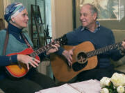 Lynda Shannon Bluestein, left, jams with her husband, Paul, in the living room of their home, Feb. 28, 2023, in Bridgeport, Conn. "Please do not make the end of life harder for me," wrote Bluestein, 75, to the Drug Enforcement Agency. In March, Bluestein, who has terminal fallopian tube cancer, reached a settlement with the state of Vermont that will allow her to be the first non-resident to use its medically assisted suicide law. By the time she's ready to use the drugs, she expects to be too ill to travel to see a doctor in person for the prescription, she wrote.