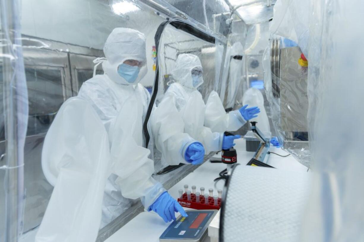 In this photo provided by Seres Therapeutics, technicians use an anaerobic chamber to prepare oral microbiome drugs for clinical studies in the company's Cambridge, Mass., facility in May 2022. On Wednesday, April 26, 2023, U.S. health officials approved the first pill made from healthy bacteria found in human waste to fight dangerous gut infections -- an easier way of performing so-called fecal transplants.