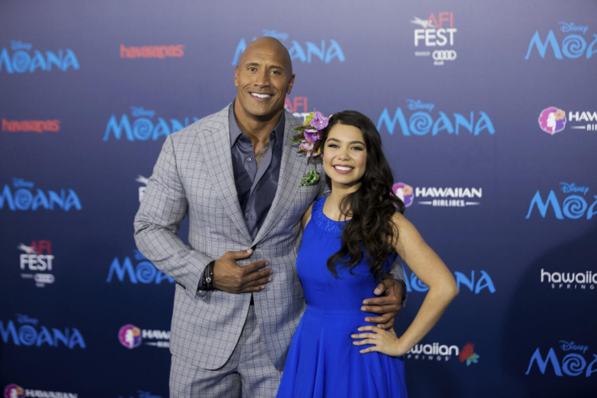 FILE - Actors Dwayne Johnson, left, and Auli'i Cravalho appear at the 2016 AFI Fest - "Moana" world premiere in Los Angeles on Nov. 14, 2016. Disney chief executive Bob Iger on Monday announced that a live-action "Moana" remake is in development in a call with investors. The production is in the early stages, but Dwayne Johnson is set to return as the demigod Maui. Cravalho, who voiced Moana in the original, is to be an executive producer on the live-action version.