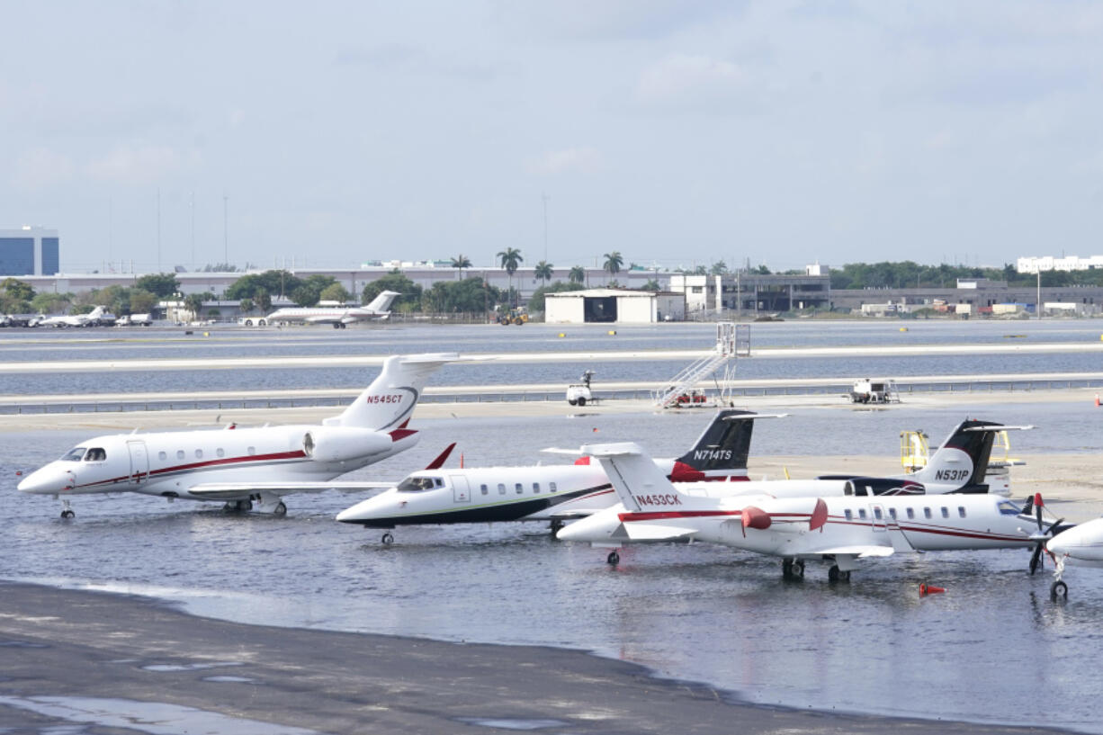 FILE - Small planes are parked at Fort Lauderdale- Hollywood International Airport, after the airport was force to shut down due to flooding, Thursday, April 13, 2023, in Fort Lauderdale, Fla. Florida Gov. Ron DeSantis Saturday, April 22, 2023, is asking the Biden administration to declare Broward County a disaster area due to flooding earlier this month after record rainfall.