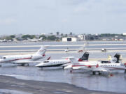 FILE - Small planes are parked at Fort Lauderdale- Hollywood International Airport, after the airport was force to shut down due to flooding, Thursday, April 13, 2023, in Fort Lauderdale, Fla. Florida Gov. Ron DeSantis Saturday, April 22, 2023, is asking the Biden administration to declare Broward County a disaster area due to flooding earlier this month after record rainfall.