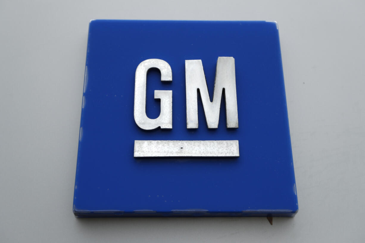 FILE - The General Motors logo is displayed outside the General Motors Detroit-Hamtramck Assembly plant, Jan. 27, 2020, in Hamtramck, Mich. General Motors is offering buyouts to most of its U.S. salaried workforce and some global executives in an effort to trim costs as it makes the transition to electric vehicles.