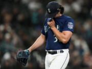 Seattle Mariners starting pitcher Robbie Ray wipes his face as he walks off of the field after being removed during the fourth inning of the team's baseball game against the Cleveland Guardians on Friday, March 31, 2023, in Seattle.