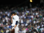 Seattle Mariners starting pitcher Logan Gilbert wipes his face after walking Cleveland Guardians designated hitter Josh Bell in the first inning during a baseball game Saturday, April 1, 2023, in Seattle.