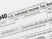 FILE - A portion of the 1040 U.S. Individual Income Tax Return form is shown July 24, 2018, in New York. The IRS has been tasked with looking into how to create a government-operated electronic free-file tax return system for all. Congress has directed the IRS to report in on how such a system might work.