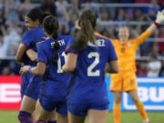 United States' Alana Cook, left, is congratulated by teammates after scoring during the first half of an international friendly soccer match against Ireland Tuesday, April 11, 2023, in St. Louis.