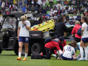 United States midfielder Lindsey Horan (10) and other players stands by as teammate Mallory Swanson receives medical attention after an injury in the first half of an international friendly soccer match against Ireland in Austin, Texas, Saturday, April 8, 2023.