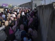 Palestinian women gather behind closed gates while they try to cross from the occupied West Bank into Jerusalem, to pray during the holiest night of Ramadan, Laylat al-Qadr, or the "Night of Destiny," when Muslims believe that the Quran was revealed to the Prophet Mohammad, in the Al Aqsa mosque compound, at the Israeli military Qalandiya checkpoint, near Ramallah, Monday, April 17, 2023. Hundreds of thousands of Palestinians are barred from legally crossing into the contested capital, with most men under 55 years old turned away at checkpoints, and compelled to resort to other, perilous means to get to Al-Aqsa.