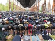 Faithful attend the final prayer of Eid al-Fitr, marking the end of Ramadan, at the Dora Park in Turin, Italy, Friday, April 21, 2023.