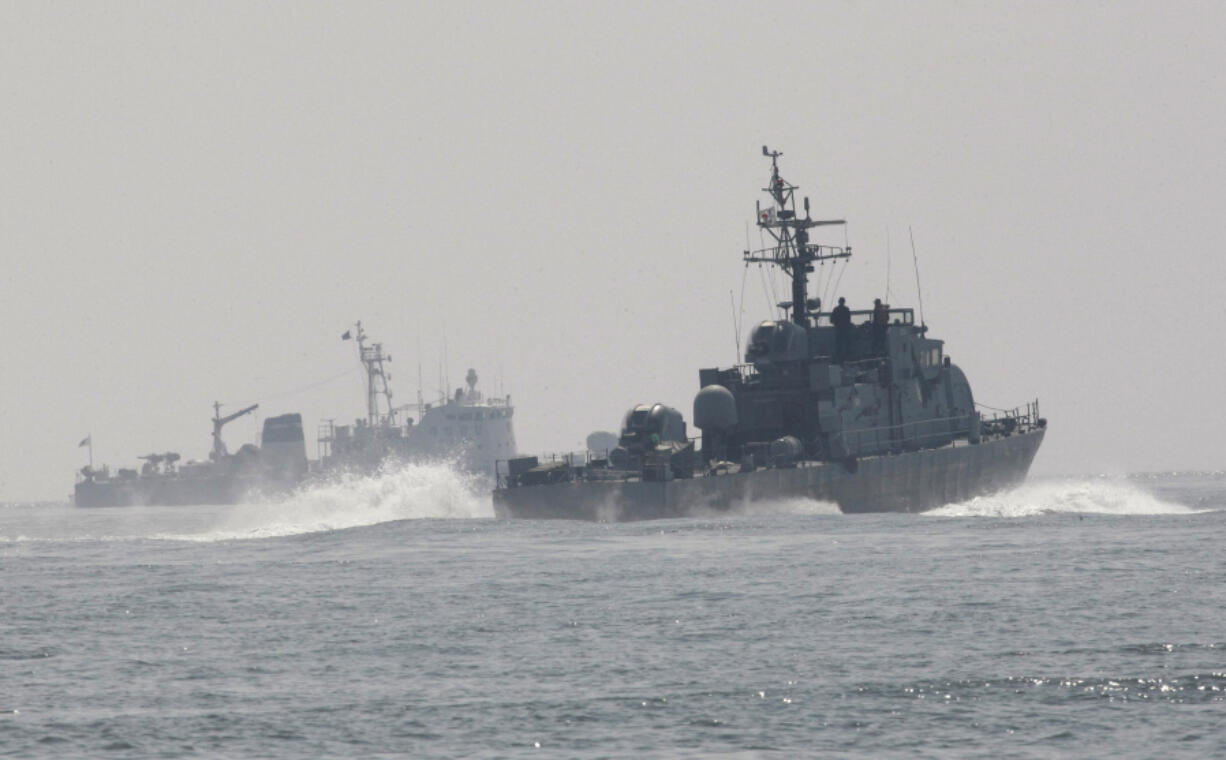 FILE - South Korean Navy's patrol ships search for survivors from the sunken South Korean navy ship near South Korea's Baekryeong island, March 29, 2010. South Korea's military said Sunday, April 16, 2023, it fired warning shots to repel a North Korean patrol vessel that temporarily crossed the countries' disputed western sea boundary while chasing a Chinese fishing boat.