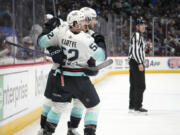 Seattle Kraken forward Tye Kartye, front, celebrates his goal against the Colorado Avalanche with defenseman Will Borgen during the second period of Game 5 of an NHL hockey first-round playoff series Wednesday, April 26, 2023, in Denver.