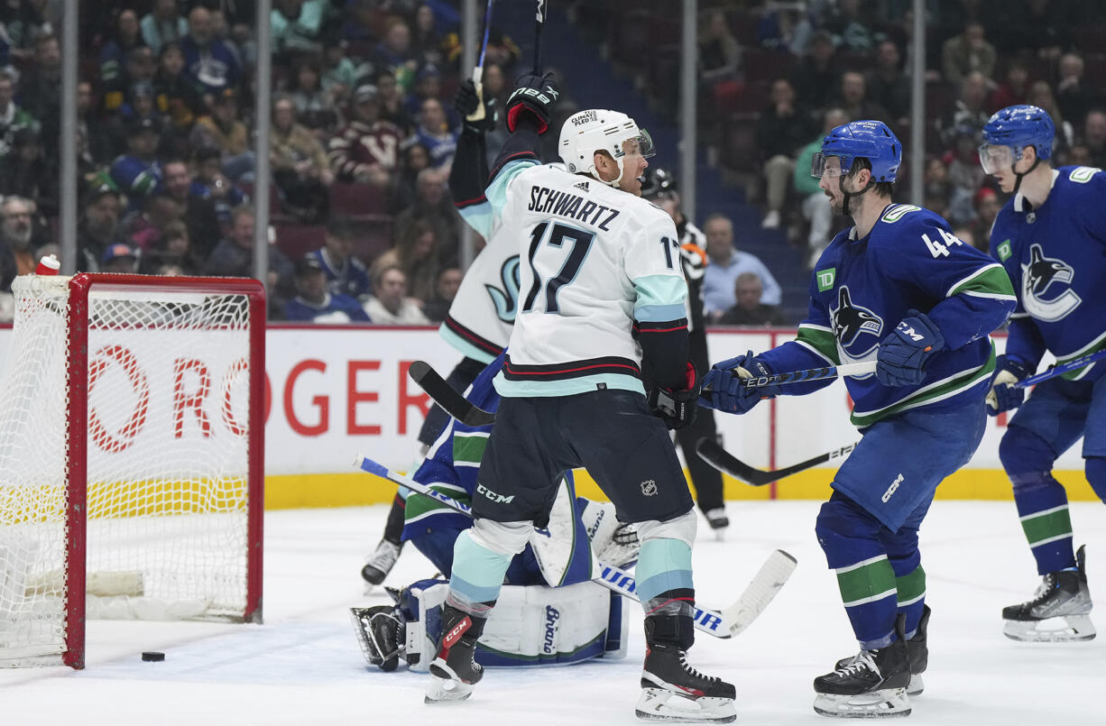 Seattle Kraken's Jaden Schwartz (17) celebrates his goal against Vancouver Canucks goalie Collin Delia in front of Canucks' Kyle Burroughs (44) during the second period of an NHL hockey game Tuesday, April 4, 2023, in Vancouver, British Columbia.