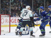 Seattle Kraken's Jaden Schwartz (17) celebrates his goal against Vancouver Canucks goalie Collin Delia in front of Canucks' Kyle Burroughs (44) during the second period of an NHL hockey game Tuesday, April 4, 2023, in Vancouver, British Columbia.