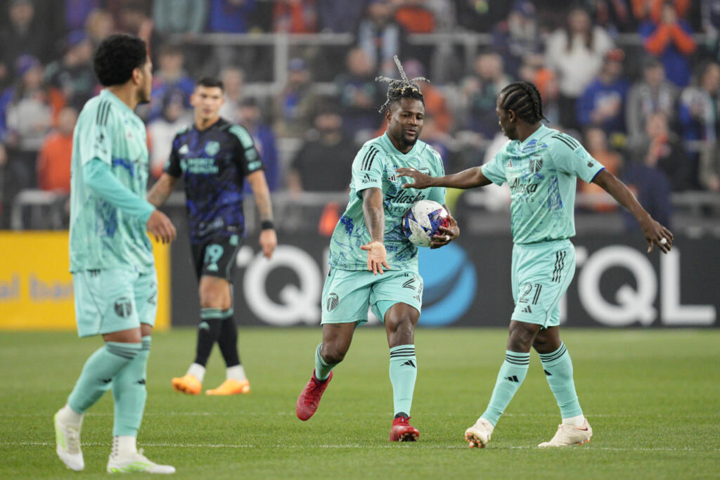 Portland Timbers' Dairon Asprilla (27) celebrates with Diego Chará (21) after scoring a goal during the second half of an MLS soccer match against FC Cincinnati Saturday, April 22, 2023, in Cincinnati.