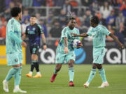 Portland Timbers' Dairon Asprilla (27) celebrates with Diego Chará (21) after scoring a goal during the second half of an MLS soccer match against FC Cincinnati Saturday, April 22, 2023, in Cincinnati.