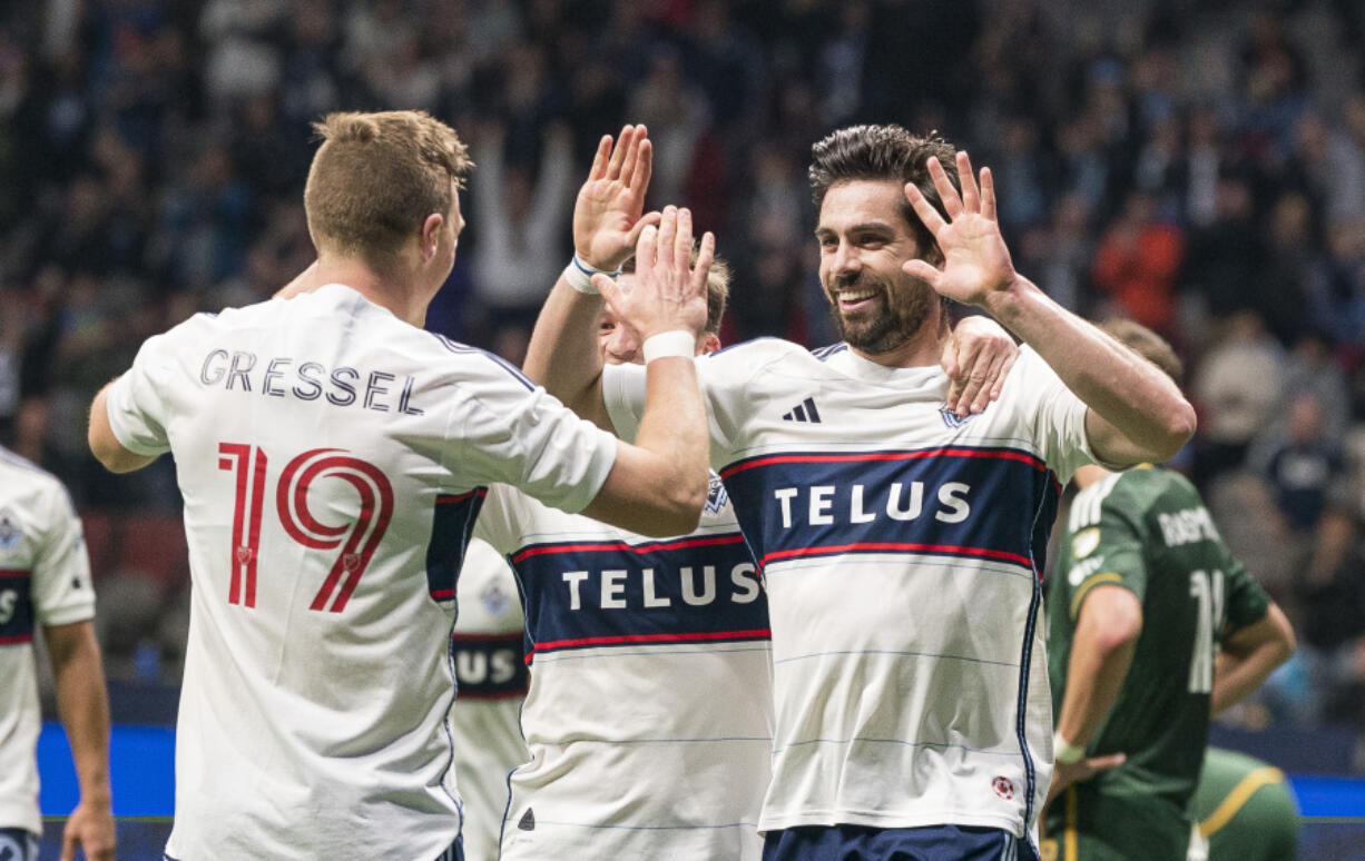 Vancouver Whitecaps' Brian White, right, celebrates with Julian Gressel after scoring a goal against the Portland Timbers during the second half of an MLS soccer match Saturday, April 8, 2023, in Vancouver, British Columbia.