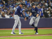 Seattle Mariners' Cal Raleigh (29), right, celebrates after his home run against the Toronto Blue Jays with third base coach Manny Acta (14) during eighth-inning baseball game action in Toronto, Sunday, April 30, 2023.