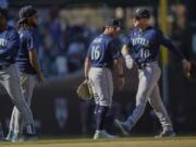 Seattle Mariners left fielder Jarred Kelenic, right, and Seattle Mariners second baseman Kolten Wong celebrate their team's 5-2 win over the Chicago Cubs after the ninth inning of a baseball game Wednesday, April 12, 2023, in Chicago.