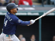 Seattle Mariners' Julio Rodriguez watches his two-run home run off Cleveland Guardians relief pitcher Nick Sandlin during the sixth inning of a baseball game Friday, April 7, 2023, in Cleveland.