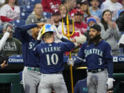 Seattle Mariners' Jarred Kelenic, center, celebrates with Julio Rodriguez, left, and J.P. Crawford, after his home run in the fifth inning against the Philadelphia Phillies on Tuesday in Philadelphia.