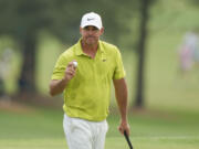 Brooks Koepka waves after his putt on the 18th hole during the first round of the Masters golf tournament at Augusta National Golf Club on Thursday, April 6, 2023, in Augusta, Ga.