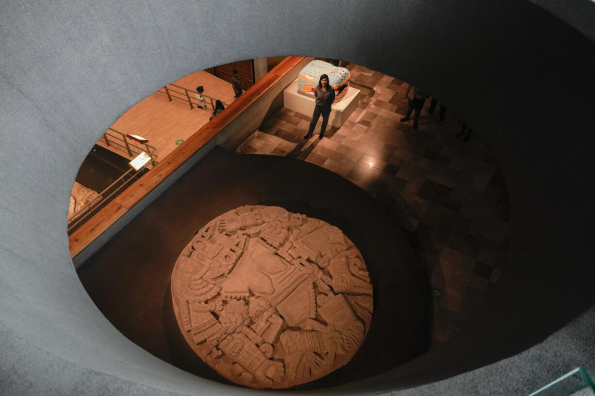 Patricia Ledesma, archaeologist and director of the Museum of Templo Mayor, poses for a photo at the entrance of a new exhibit marking the 45th anniversary of the discovery of a monolith depicting Coyolxauhqui, the Mexica lunar goddess, in Mexico City, Wednesday, March 29, 2023. Ledesma said that her predecessors undertook the task of rescuing the traces of the Mexica civilization after the colonial era, in 1821.