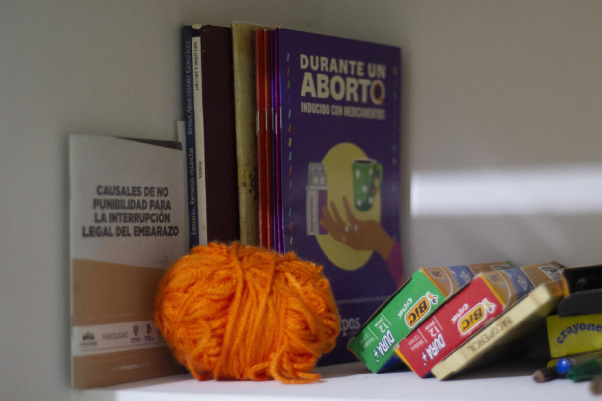 Books on abortion issues sit at the Marea Verde Chihuahua, an organization that supports reproductive rights, in Chihuahua, Mexico, Monday, March 13, 2023. To safely advise women on self-managed medical abortions, members of Marea Verde Chihuahua were trained to become "acompa?antes" -- capable of serving as a guide and partner, whether in person or from long distance.