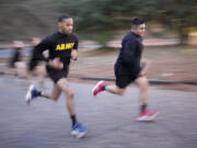 Army Staff Sgt. Daniel Murillo, right, runs up hill as part of his physical training at Ft. Bragg on Wednesday, Jan. 18, 2023, in Fayetteville, N.C. Obesity in the U.S. military surged during the pandemic, new research shows. Nearly 10,000 active duty Army soldiers became newly obese between February 2019 and June 2021, after restricted duty and limited exercise led to higher body mass scores.