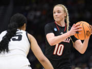 Louisville guard Hailey Van Lith (10) looks for a pass as Iowa forward Hannah Stuelke defends in the second half of an Elite 8 college basketball game of the NCAA Tournament, Sunday, March 26, 2023, in Seattle.