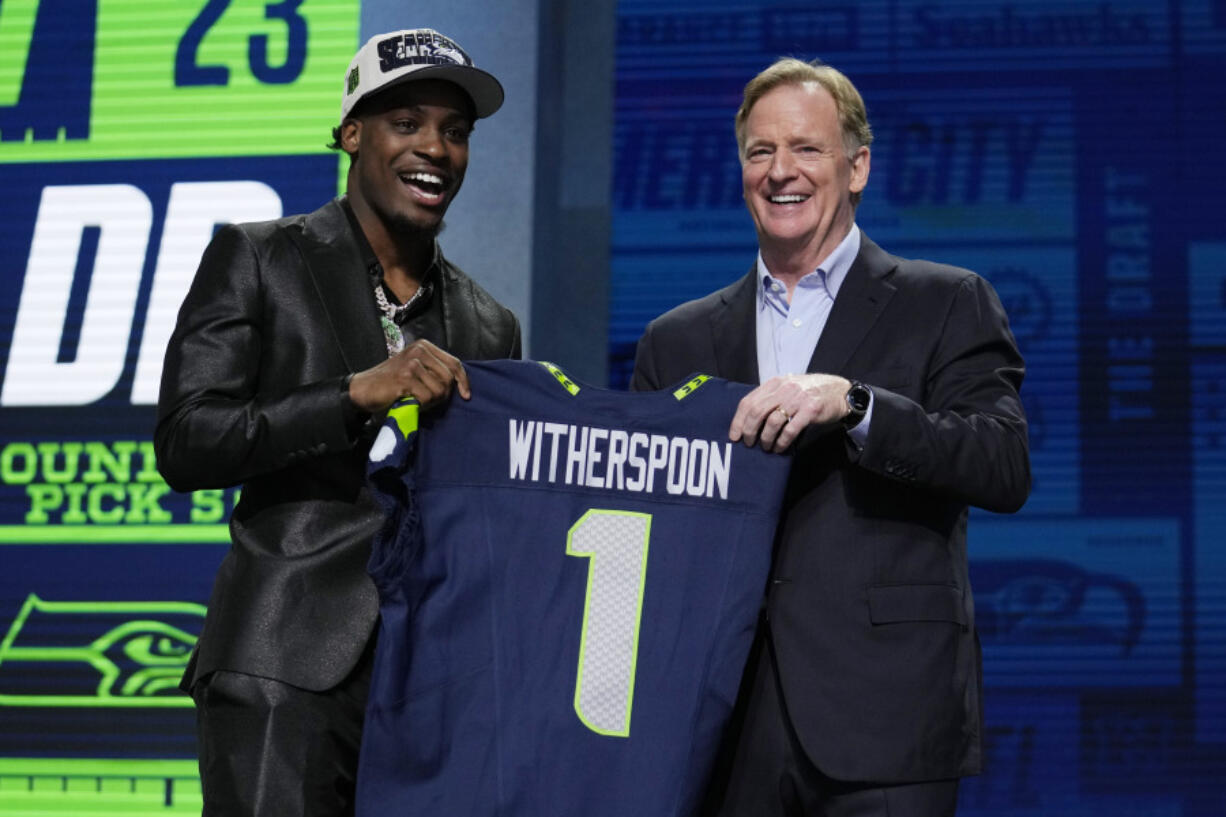 Illinois defensive back Devon Witherspoon, left, stands with NFL Commissioner Roger Goodell after being chosen by the Seattle Seahawks with the fifth overall pick during the first round of the NFL football draft, Thursday, April 27, 2023, in Kansas City, Mo.